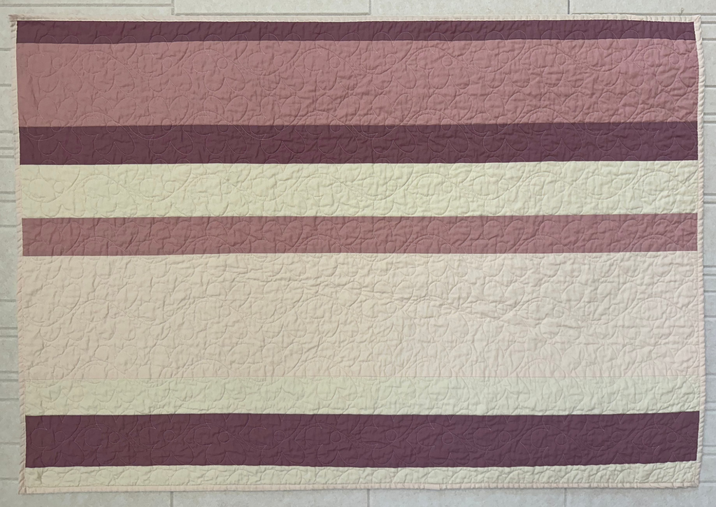 Pink Striped Quilt with Floral Stitching