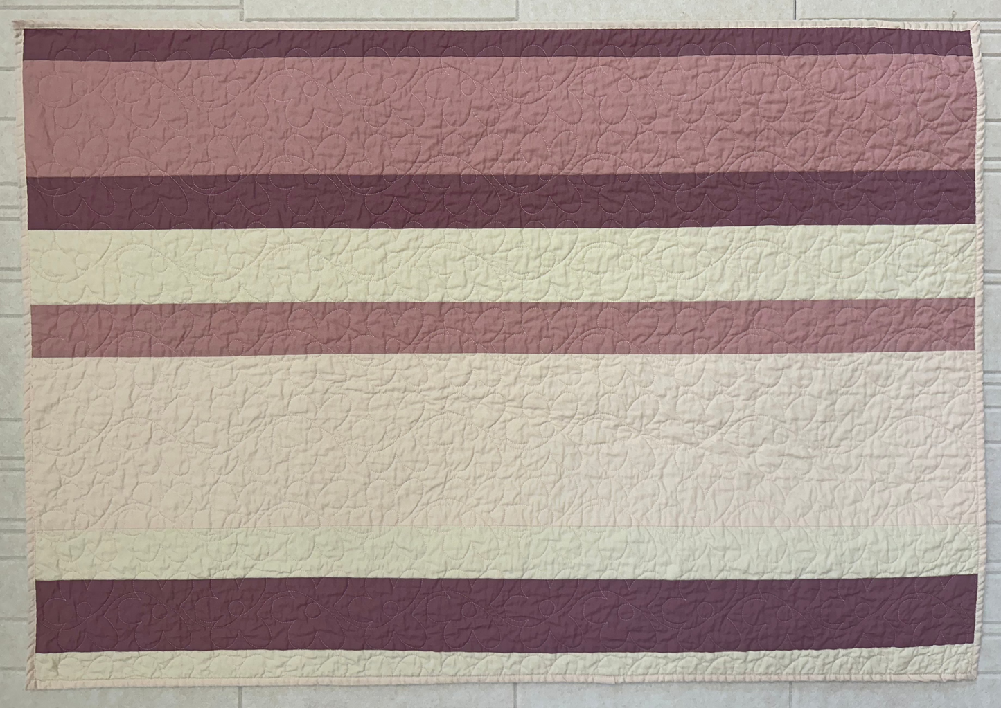 Pink Striped Quilt with Floral Stitching